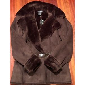 Estudio woman winter jacket with a fur lining and a belt closure in front.
